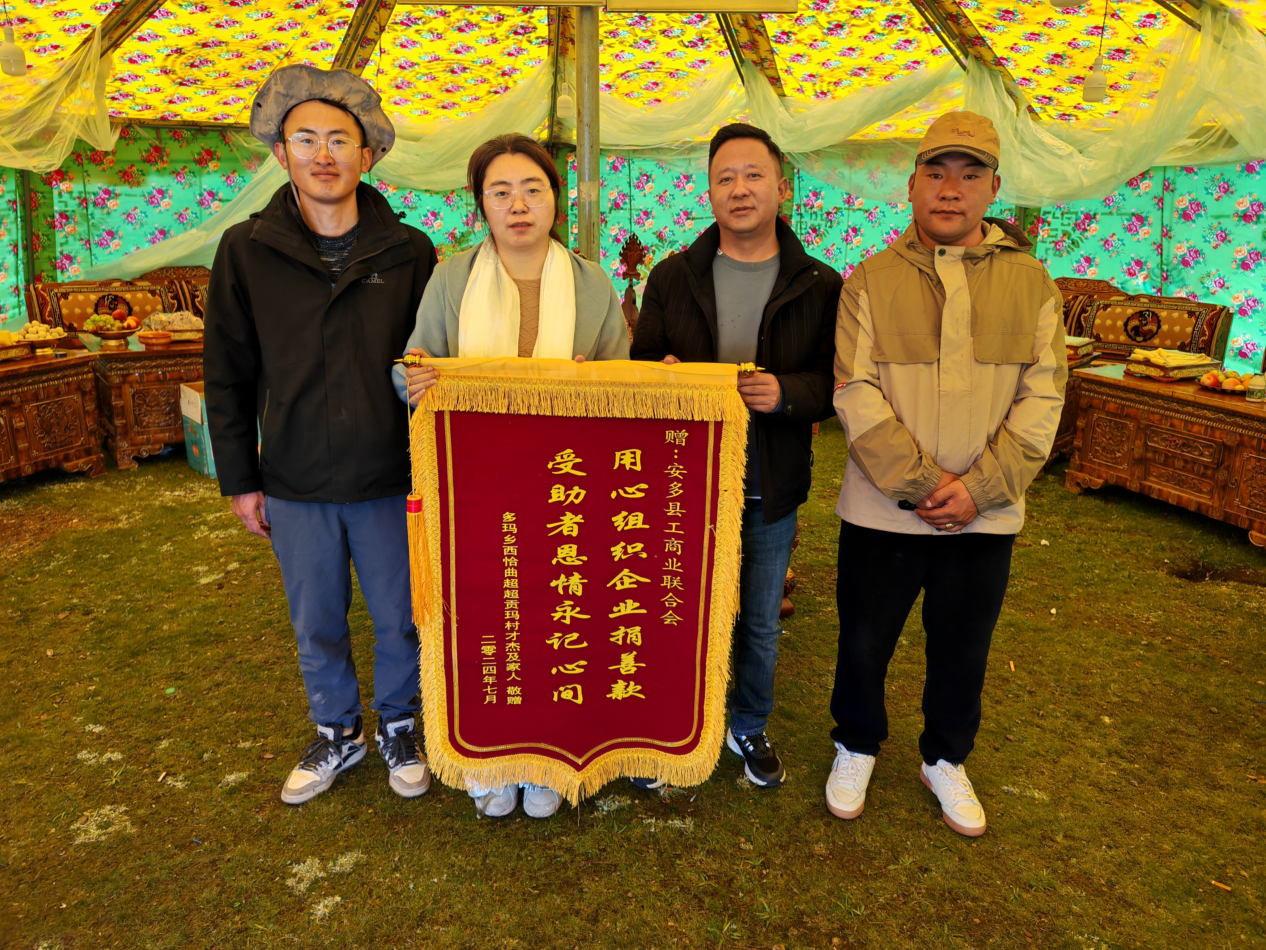 圖為多瑪鄉(xiāng)人大主席多吉次旦（右二）帶領(lǐng)駐村工作隊向縣委統(tǒng)戰(zhàn)部副部長、工商聯(lián)主席周利君（左二）敬獻(xiàn)錦旗.jpg